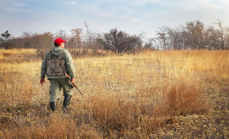 deer hunter locating a whitetail buck