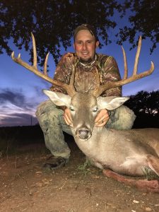 Hunter with a White Tailed Deer Buck