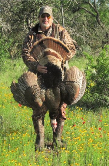 Turkey hunter holding a tagged turkey