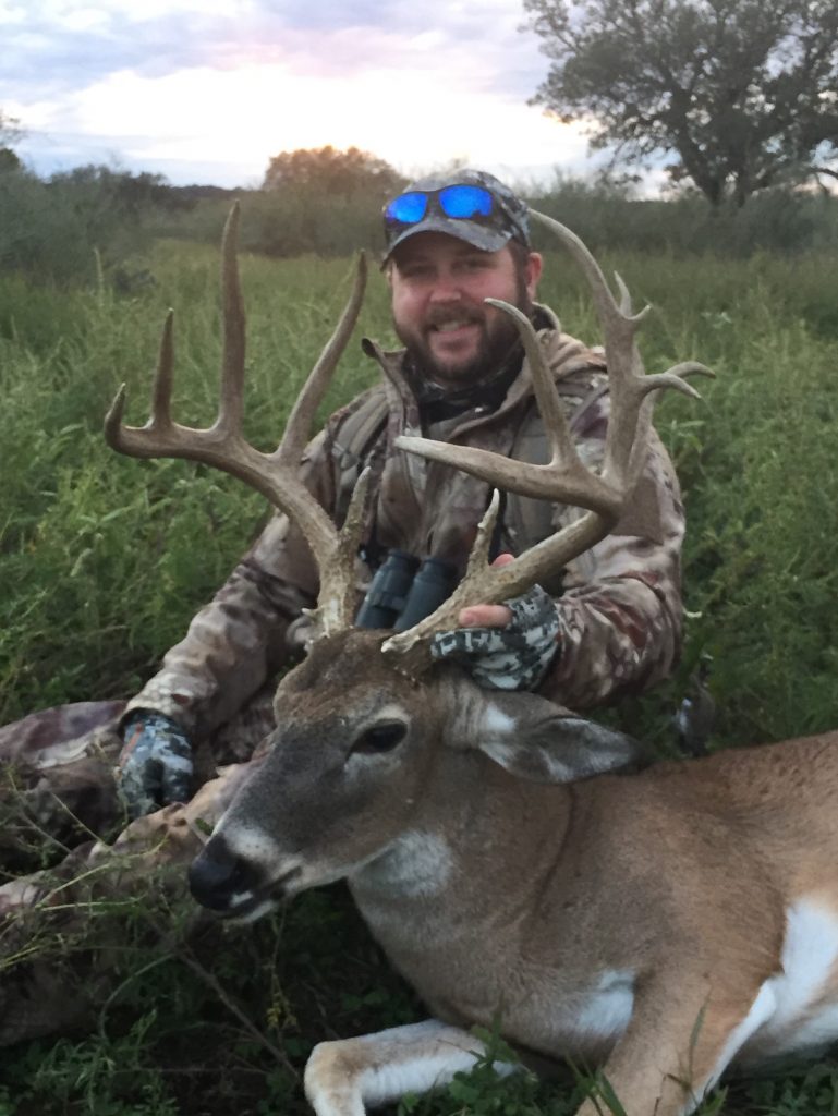 Whitetail deer hunter with trophy in Texas